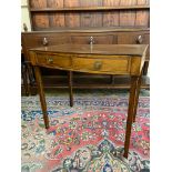 A mahogany bow fronted two drawer side table raised upon square tapering supports, 19th Century