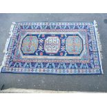 A large Eastern rug of multi-coloured design, with three large central medallions, within a