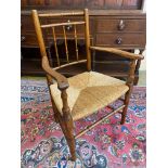 A 19th Century faux bamboo rush seated armchair.