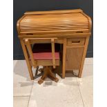 A mid-century beech child's roll top desk and matching rexine covered swivel chair, 27