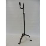An early 19th Century wrought iron adjustable floor standing rushlight and candle holder, 26" h.