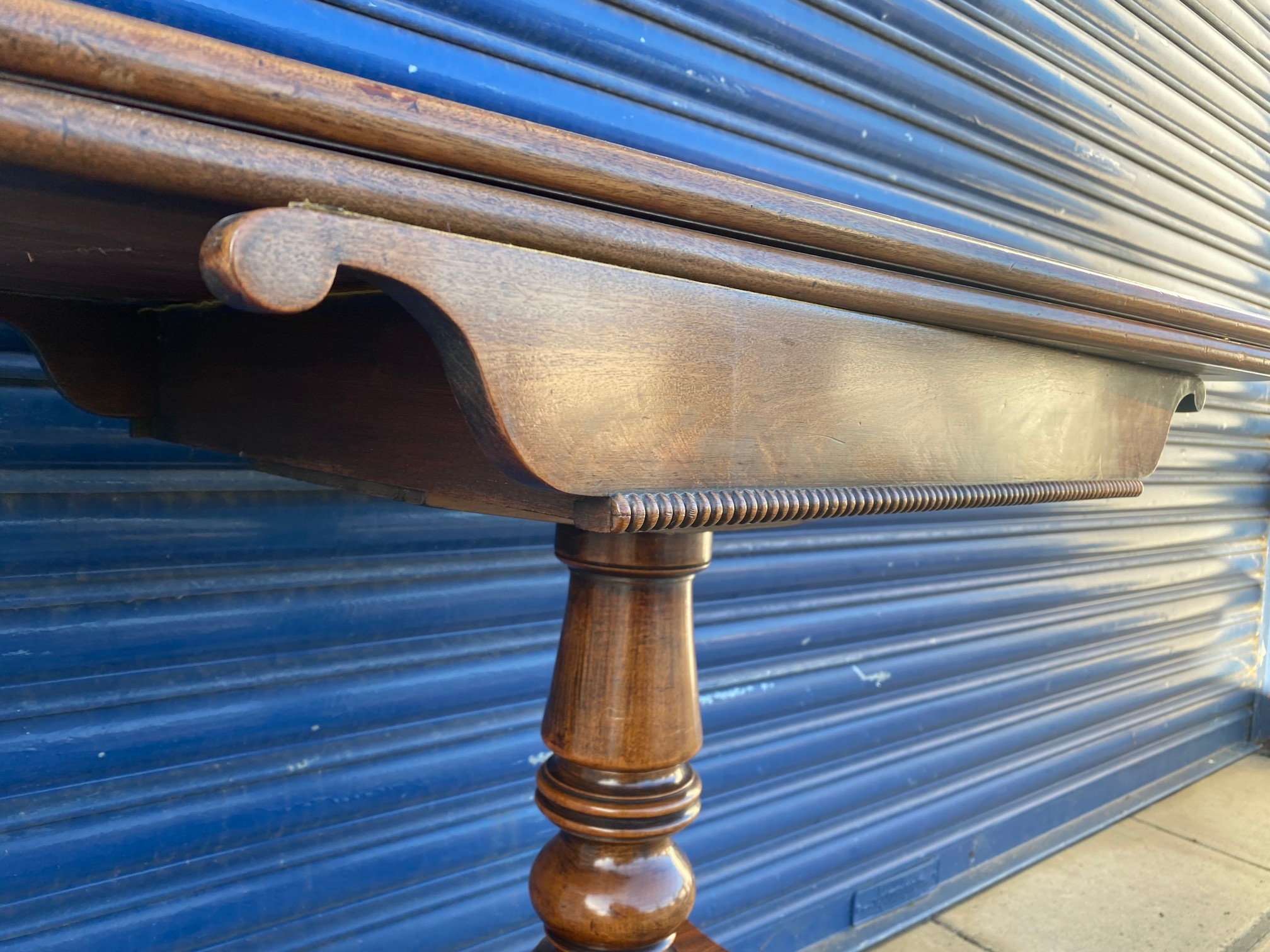 An early 19th Century mahogany fold over card table, raised upon a turned stem to splayed supports. - Image 5 of 6