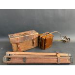 A leather cased 19th Century mahogany camera, with extra plates and folding stand.