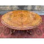 A very good Victorian burr walnut oval tilt top table of high quality raised upon an open 'basket'