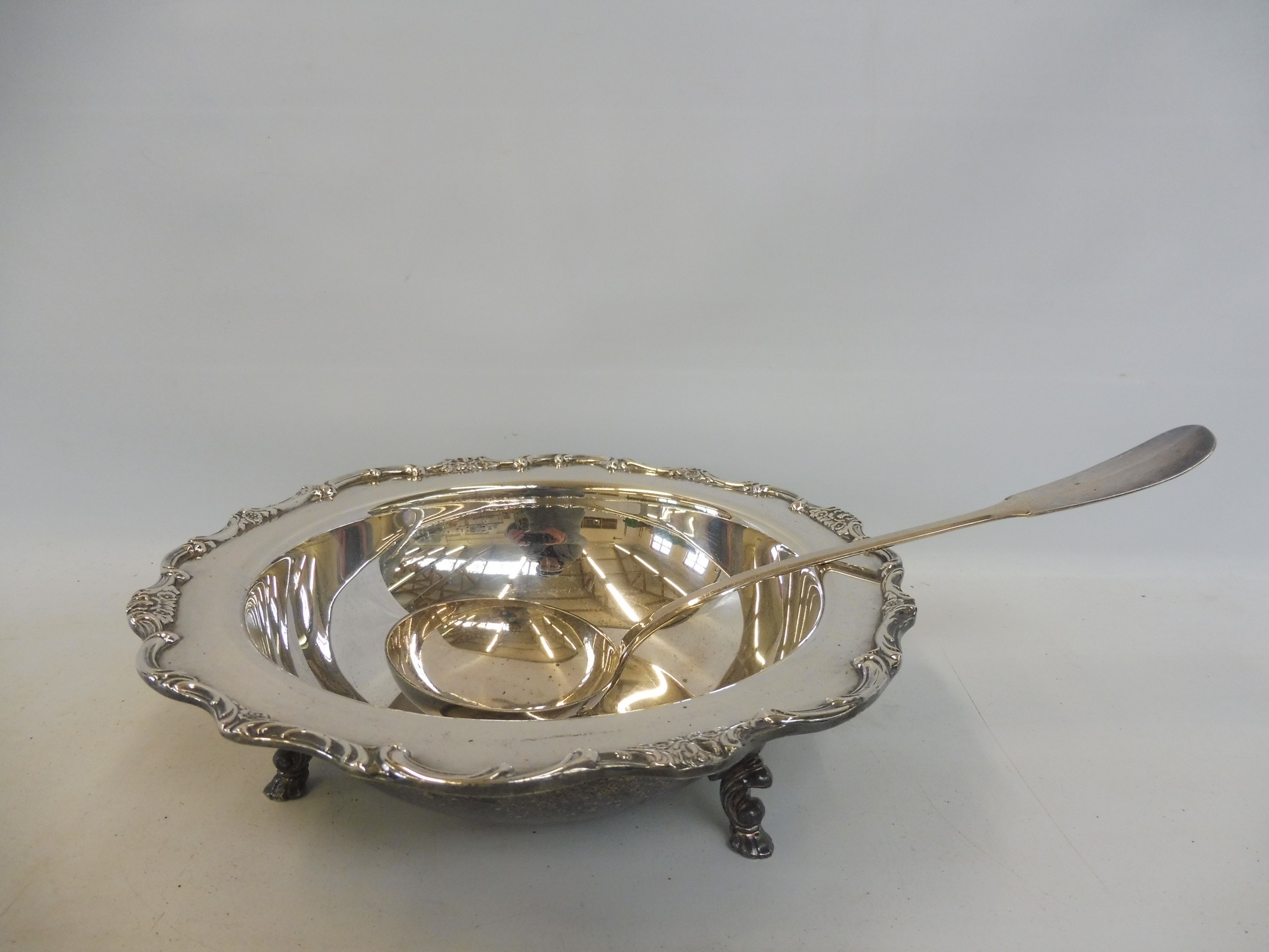 A good quality silver plated serving dishes raised upon three hoof supports, plus a white metal