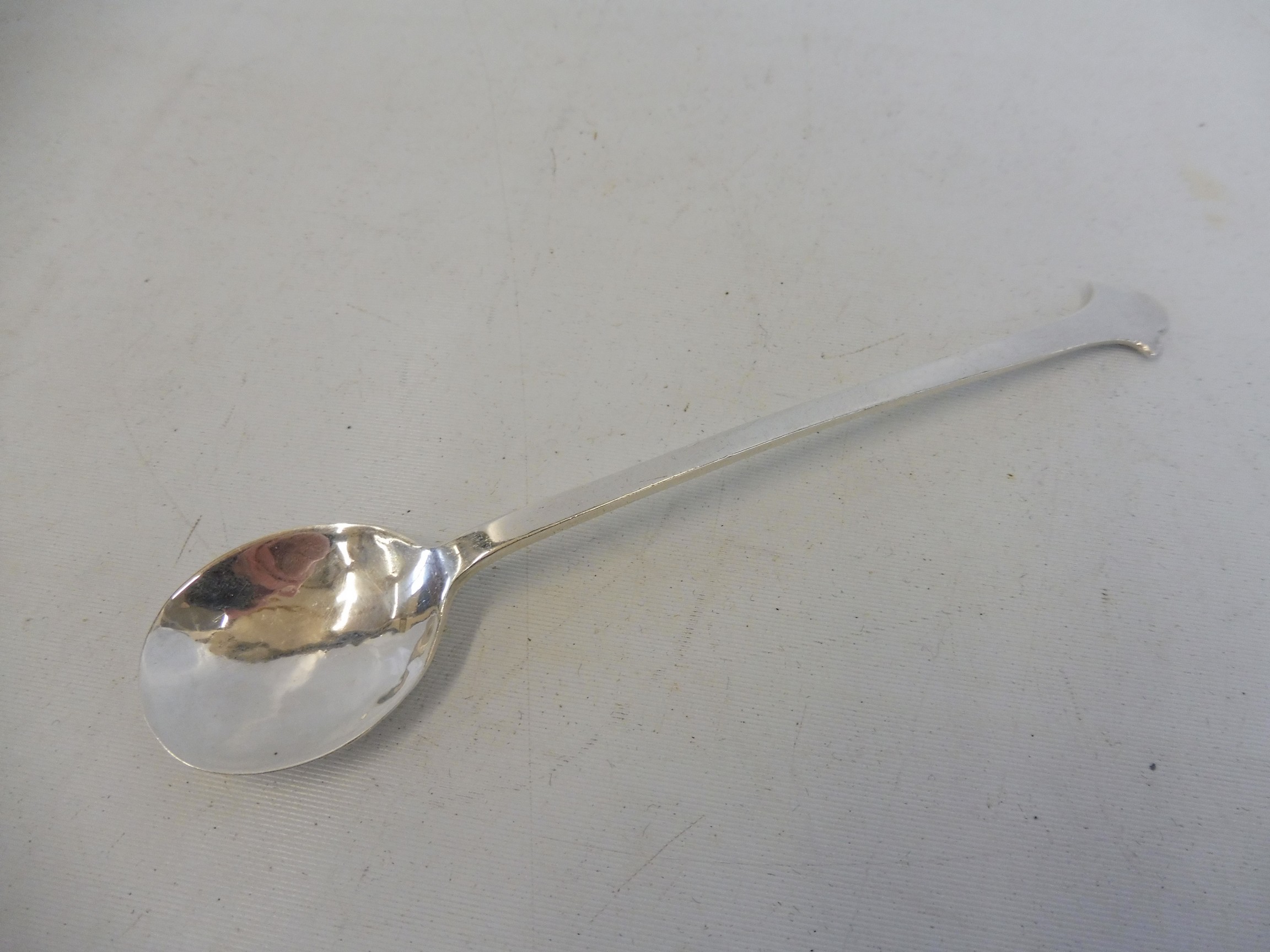 A hammered silver honey spoon, in the Arts and Crafts style, Sheffield 1932, maker C.B & S.