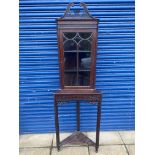 An Edwardian mahogany two piece floor standing corner cabinet on stand with fretwork swan neck