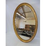 An Edwardian gilt framed oval wall mirror, 23 x 33".