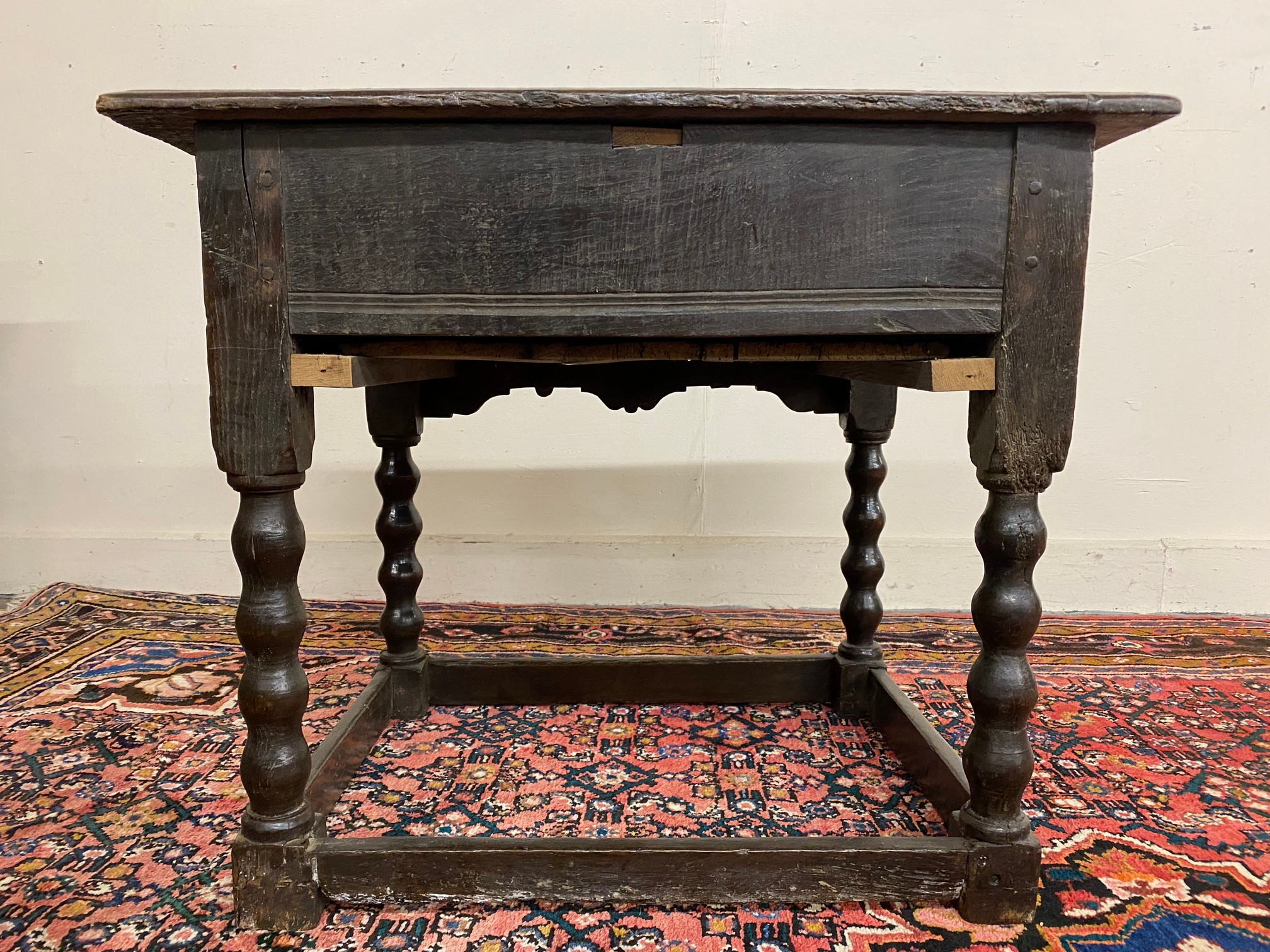 A primitive 17th Century Welsh oak side table with bobbin supports, 30 1/2" w x 26" h x 23" d. - Image 9 of 15