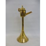 An 18th Century brass whale oil lamp on a column with wall hanging aperture, 16 1/2" h.