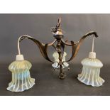 An Art Nouveau light fitting with three vaseline glass shades.