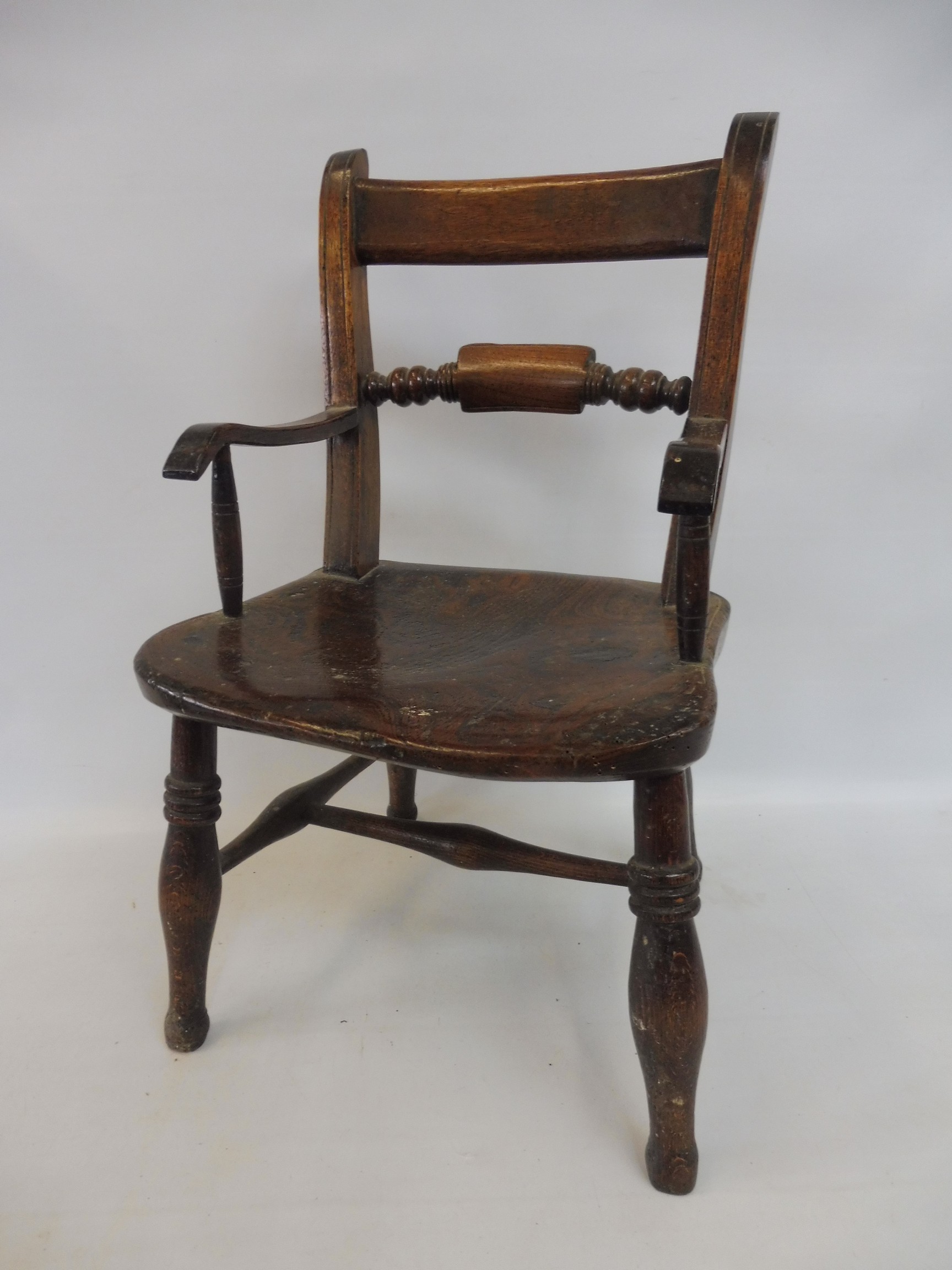 An elm seated child's Oxford style armchair.