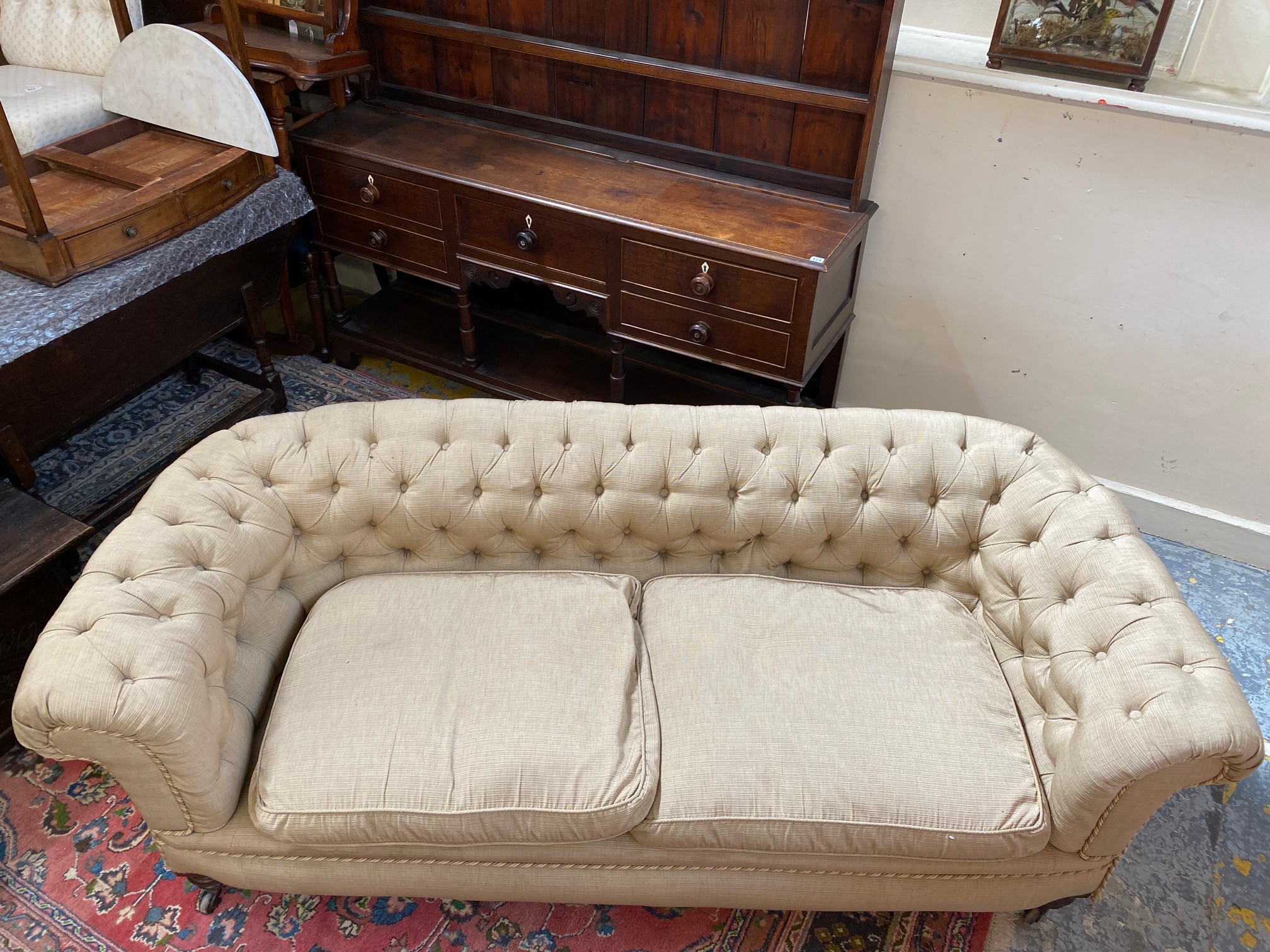 A late Victorian Howard style button back upholstered chesterfield sofa raised upon turned front - Image 2 of 5