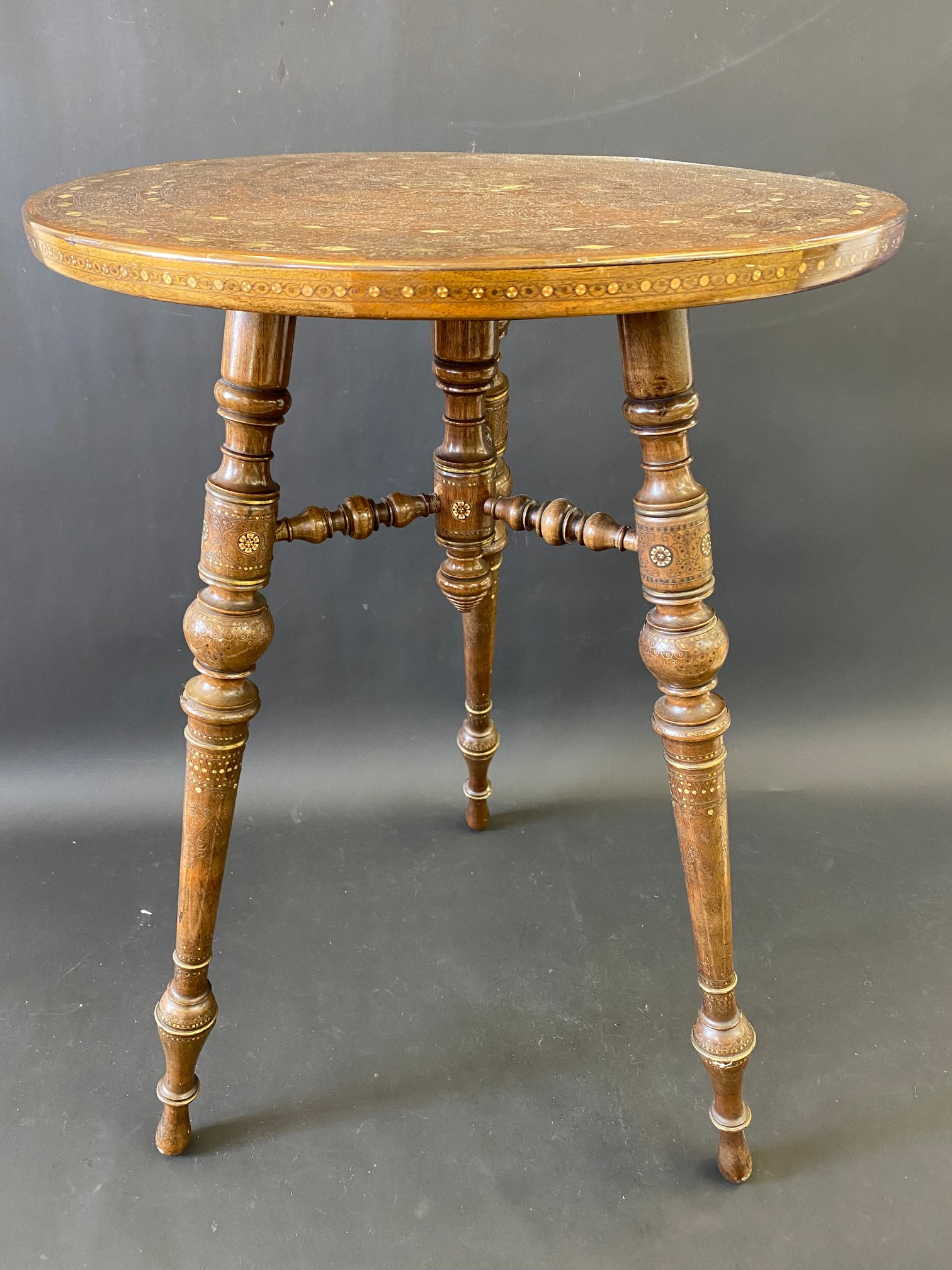 A very good quality 19th Century Moorish heavily inlaid circular occasional table raised on three