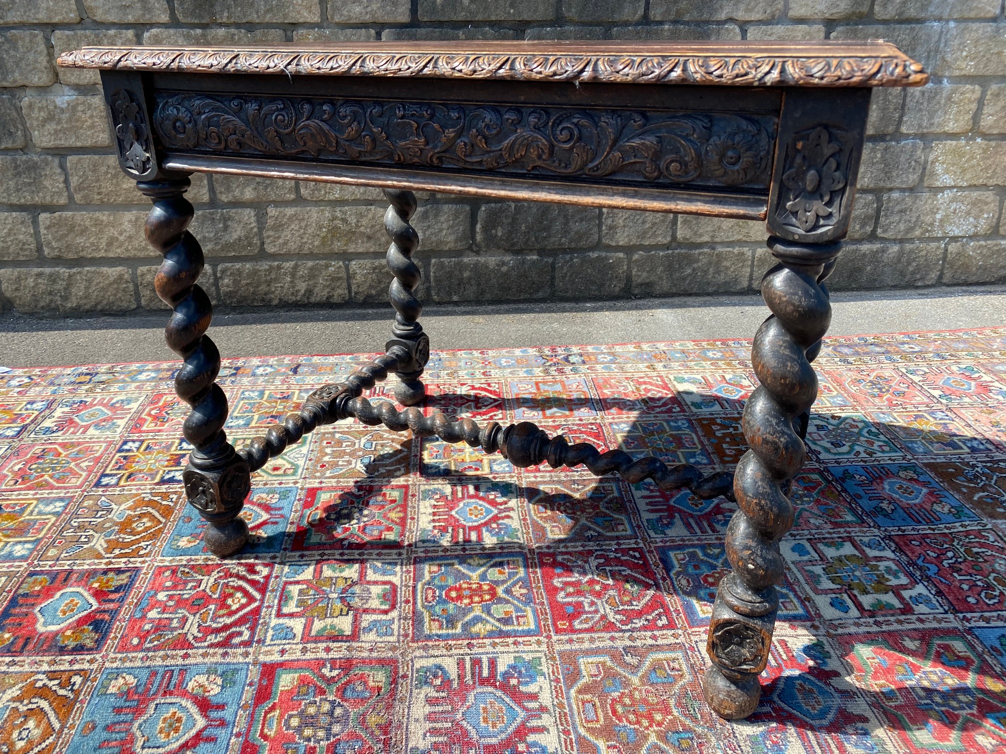 A Victorian carved oak single drawer side table raised upon barley twist supports joined by a - Image 2 of 4