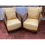 A pair of Art Deco walnut framed begere armchairs.