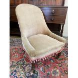A Victorian upholstered nursing chair raised upon rosewood supports to brass castors.