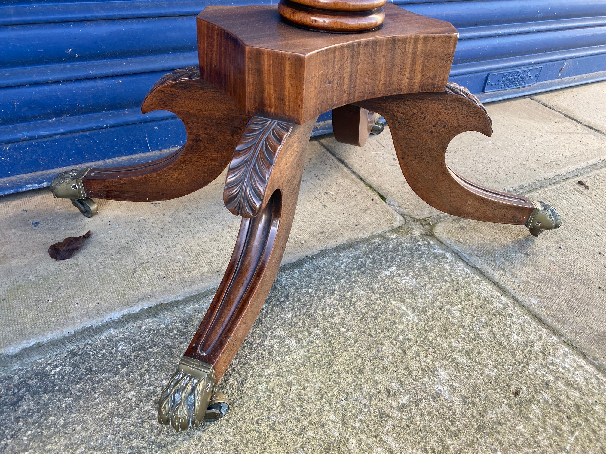 An early 19th Century mahogany fold over card table, raised upon a turned stem to splayed supports. - Image 6 of 6