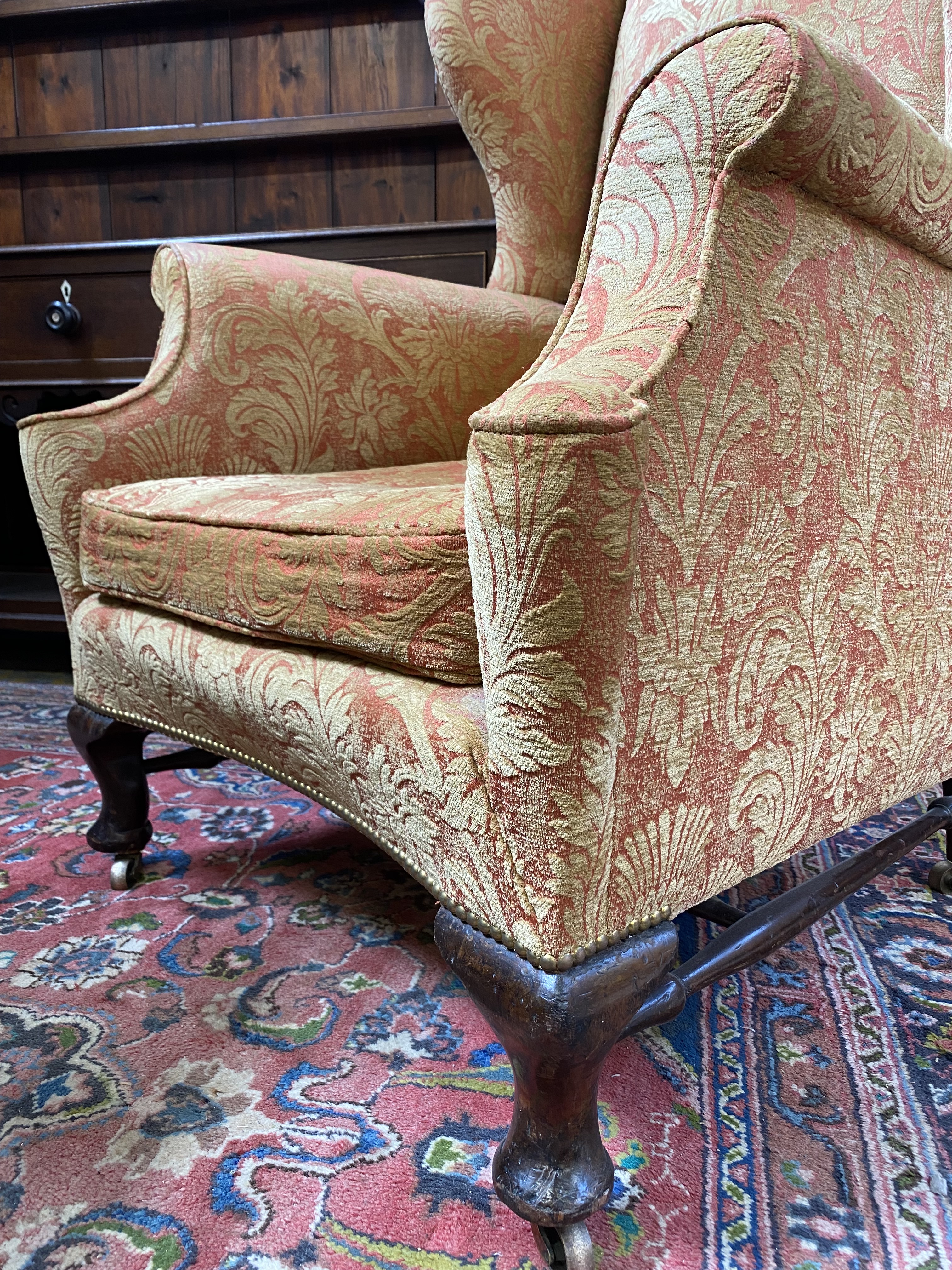 An upholstered wing back armchair raised upon mahogany supports, joined by a stretcher, probably - Image 2 of 7