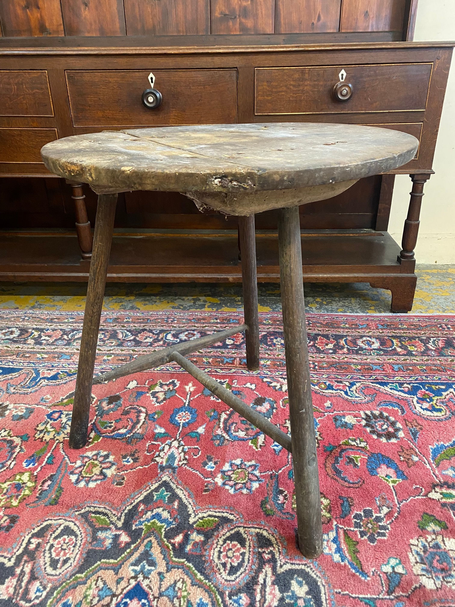 A rare 19th Century or possibly earlier Welsh borders cricket table with a fruitwood top and ash