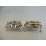 A pair of Victorian silver three footed salts by Henry Holland, London 1857, with later clear