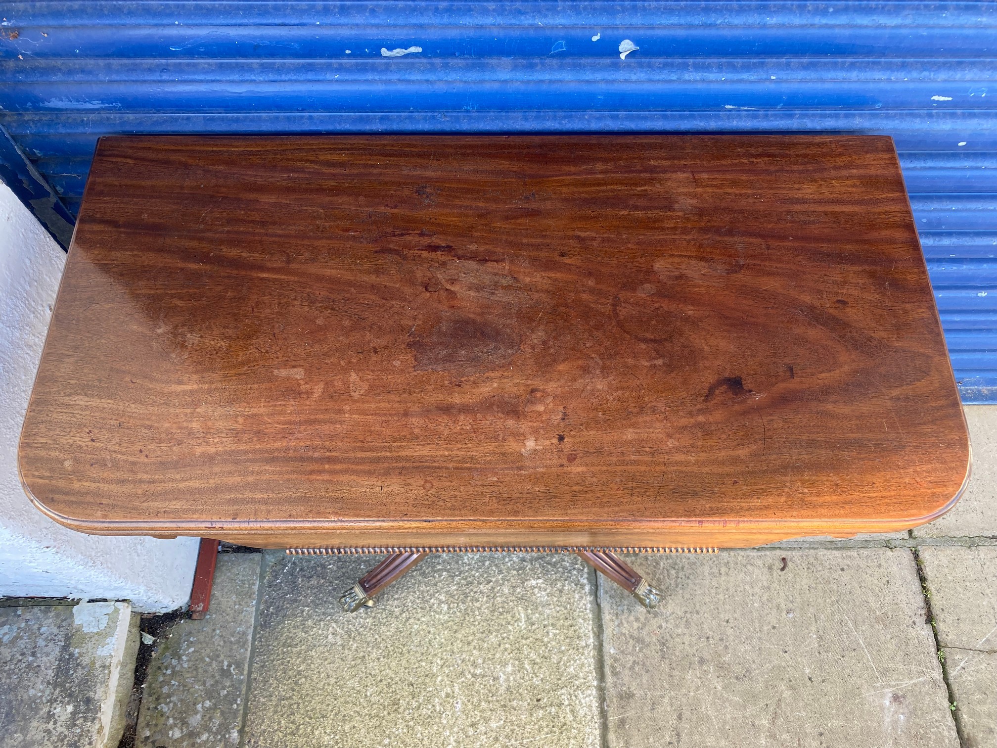 An early 19th Century mahogany fold over card table, raised upon a turned stem to splayed supports. - Image 3 of 6