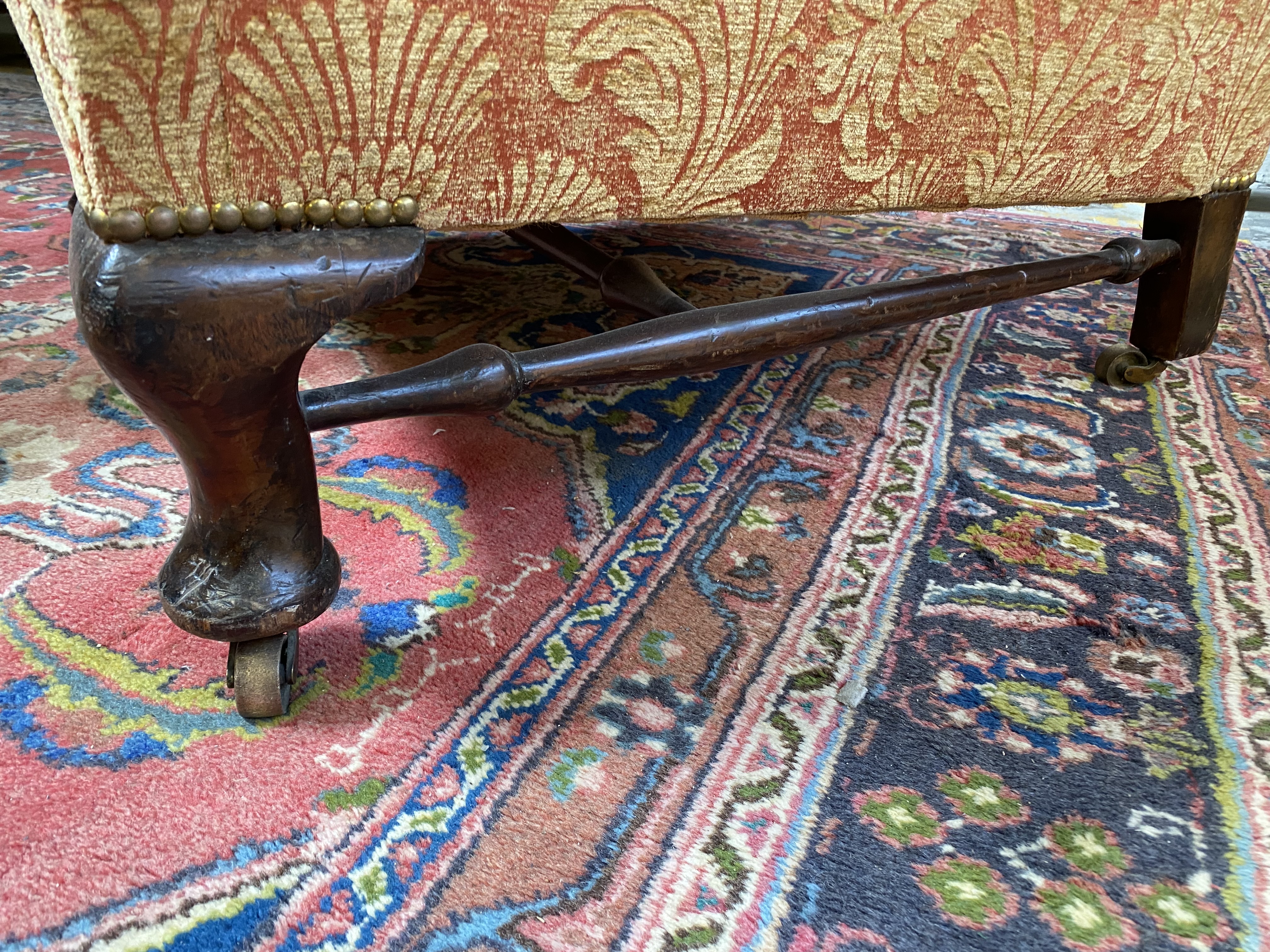 An upholstered wing back armchair raised upon mahogany supports, joined by a stretcher, probably - Image 4 of 7