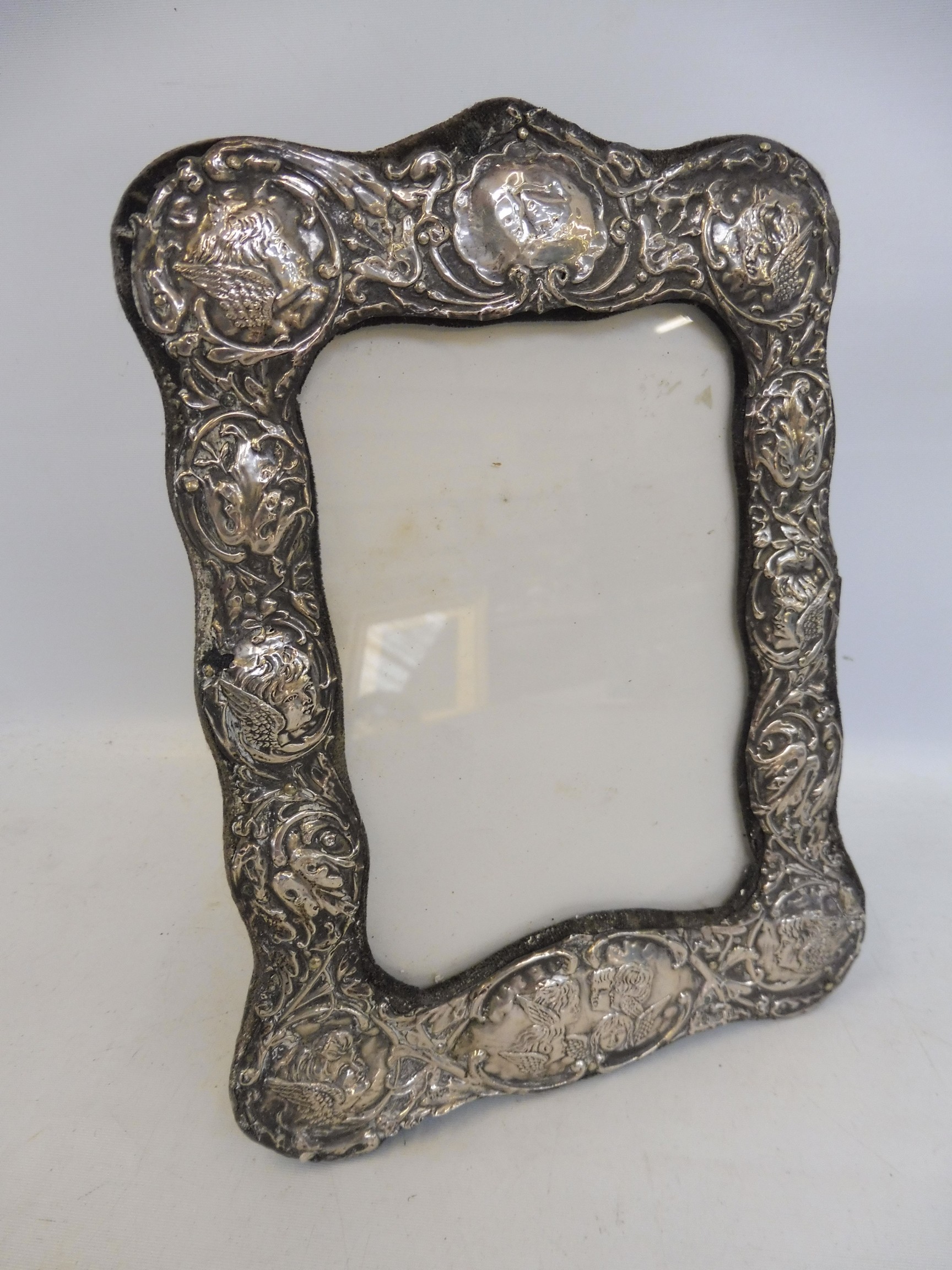 A silver photograph frame, with cherubic decoration, Birmingham 1907.