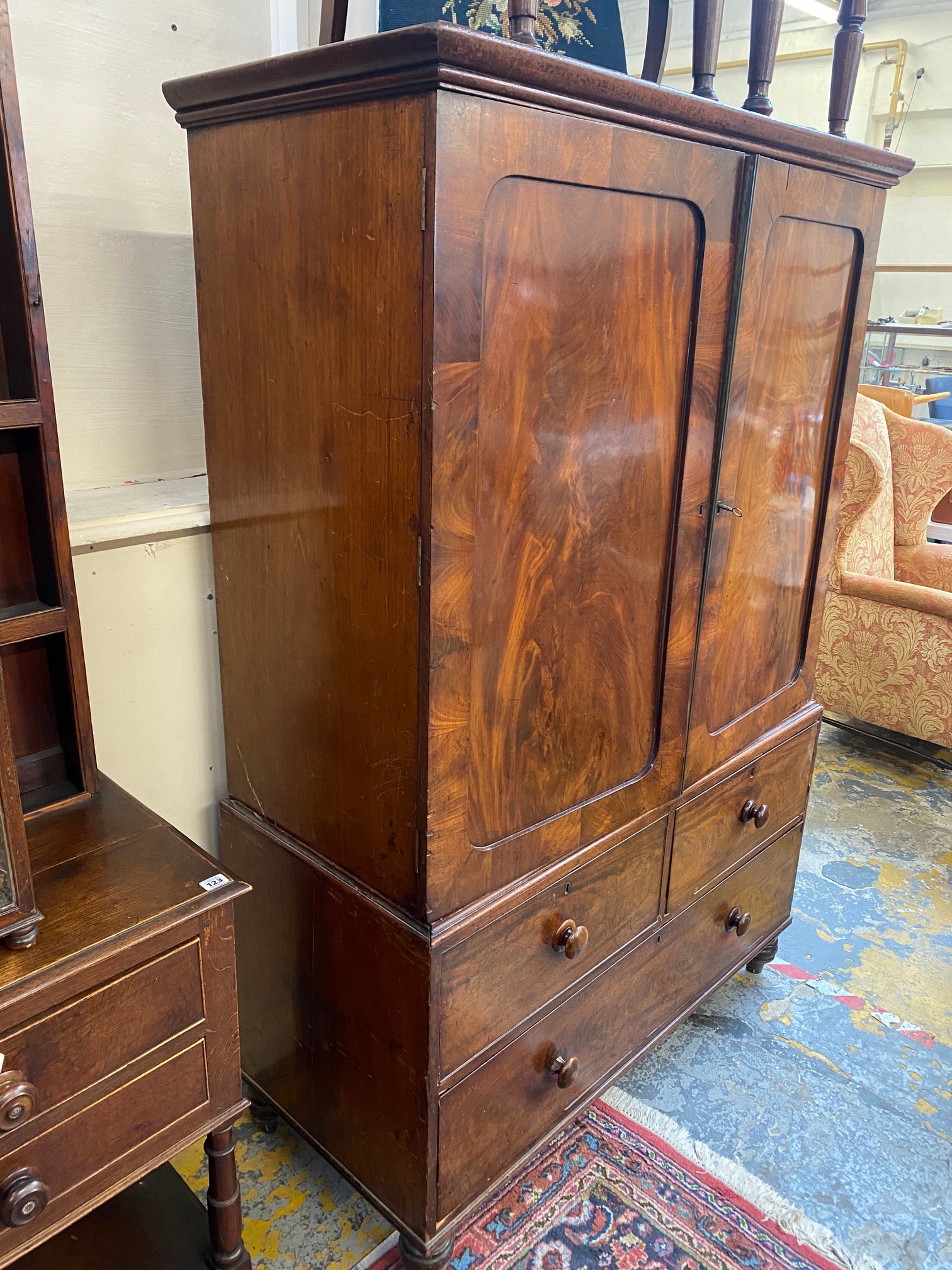 An early 19th Century mahogany linen press of two panelled doors enclosing slides, above a three - Image 8 of 8