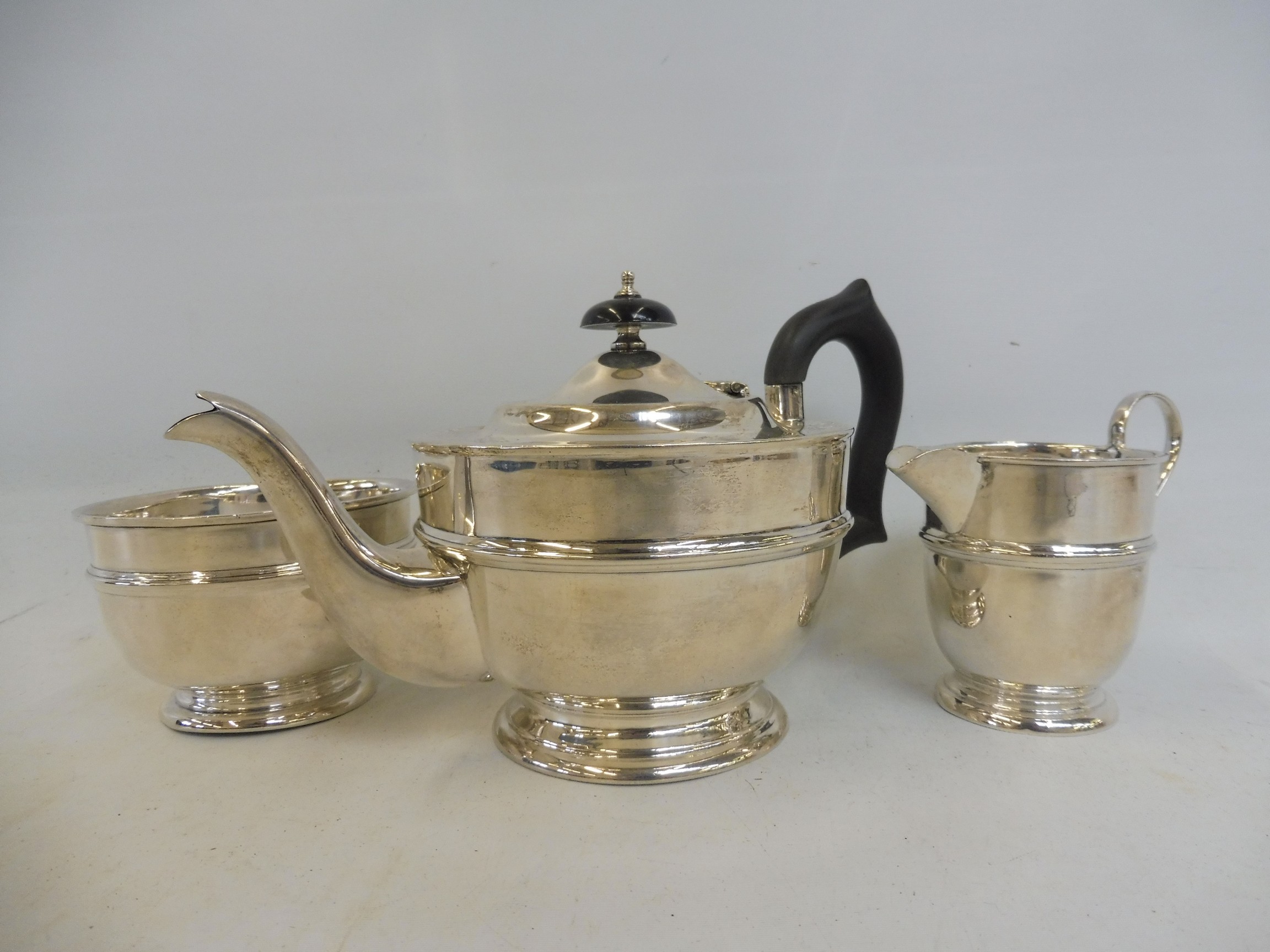 A silver three piece tea set comprising teapot, sugar bowl and milk jug, Sheffield 1931.