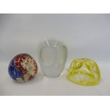 A yellow glass paperweight with a spider in web design, a glass paperweight in the shape of an owl