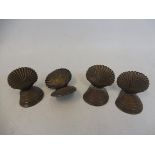 Four shell shaped menu/place setting holders.