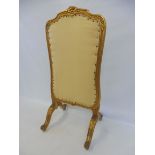 A gilt framed fire screen, 16 1/2" wide x 34" high x 15" deep (at feet).