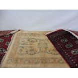 A pair of red Pakistani prayer rugs, each approx. 40 x 26" and an Eastern prayer rug of pale gold