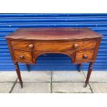 An early 19th Century mahogany bow fronted desk of a single drawer above two smaller drawers, raised