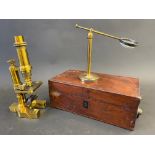 A good quality laquered brass microscope in a mahogany case, plus a table top laquered brass
