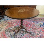 A 19th Century mahogany circular tilt top tea table raised upon a tripod base, 28" diameter.