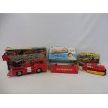 A boxed circa 1960s Marx Fire engine, a Made in Hong Kong Magic Bulldozer and a cable car.