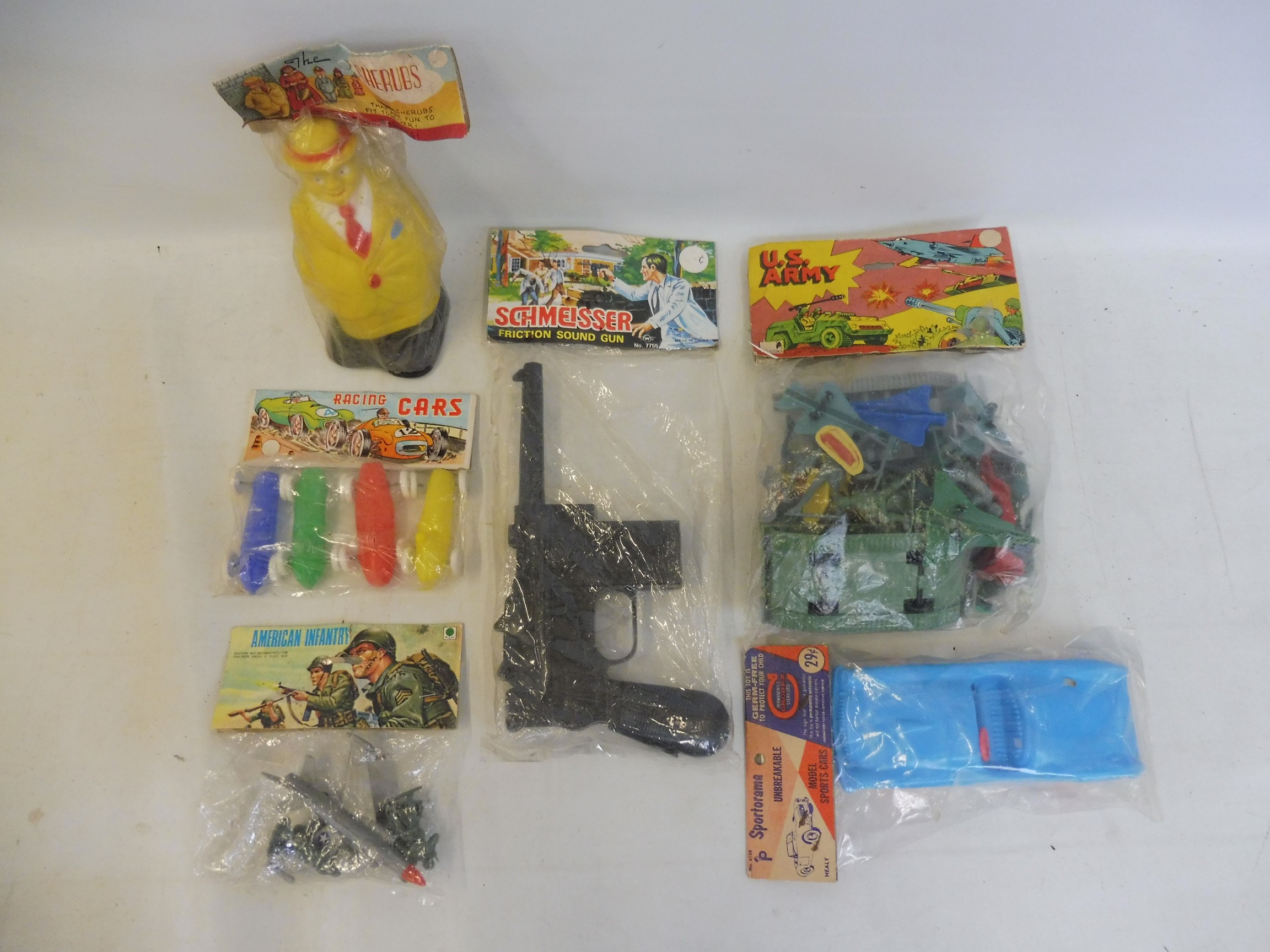 A mixed box of early plastics all sealed in original packs, including a Schmeisser sound gun.