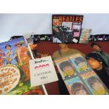 A box full of Beatles memorabilia to include a Beatles blanket, poster and an original 1964