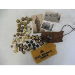 A small box of military buttons, military photographs etc. plus a Civil Defence Corps armband.