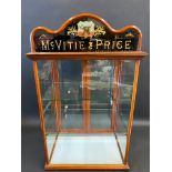 A McVitie & Price counter top dispensing cabinet with pictorial glass pediment and two rear