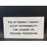 A small information sign relating to the attendant not accepting responsibility for luggage or