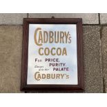 An oak framed advertising mirror, with lettering for Cadbury's Cocoa, possibly of later manufacture,