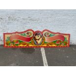 A highly decorated panel from the top of a juvenile fairground ride, painted in the 1970s, but never