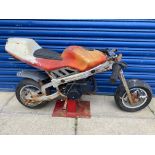 A juvenile fairground motorbike, which integrates original bike parts, for restoration.