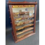 A mahogany cased counter top dispensing cabinet for Marcus's Superb Cigarettes, with six drawers