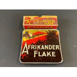 An Afrikander Flake curved tin in good condition plus a similar cardboard box.