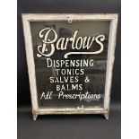 A wooden framed glass partial sash window, with hand painted advertising for 'Barlows Dispensing