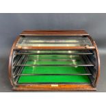 A rare Maw & Son mahogany counter top display cabinet with lift up curved glass front, revealing